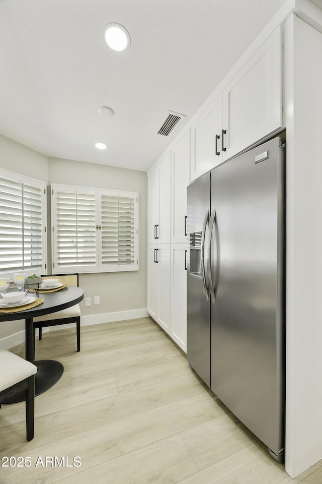 10538 E Gold Dust Cir, Scottsdale, AZ 85258 - kitchen featuring stainless steel fridge, white cabinetry, light wood-type flooring, and recessed lighting