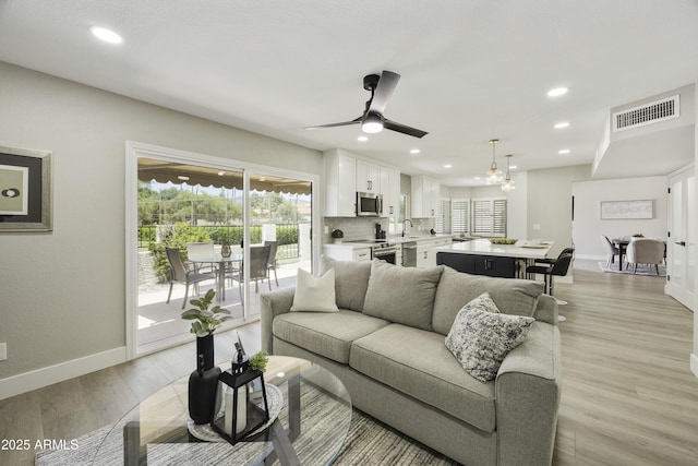 10538 E Gold Dust Cir, Scottsdale, AZ 85258 - living area with ceiling fan, light wood finished floors, and recessed lighting