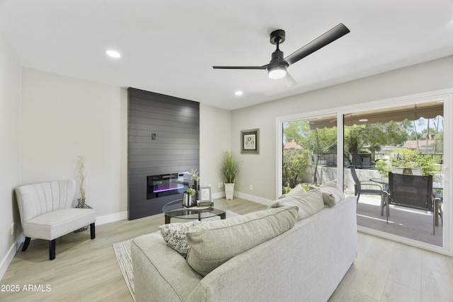 10538 E Gold Dust Cir, Scottsdale, AZ 85258 - living area with a large fireplace, light wood finished floors, ceiling fan, and recessed lighting