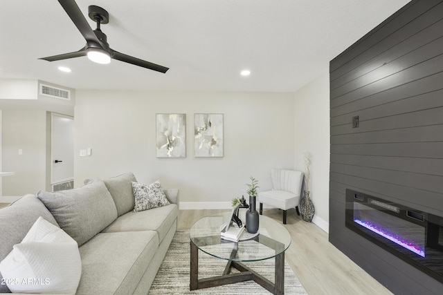 10538 E Gold Dust Cir, Scottsdale, AZ 85258 - living room featuring a ceiling fan, recessed lighting, light wood-style flooring, and a large fireplace
