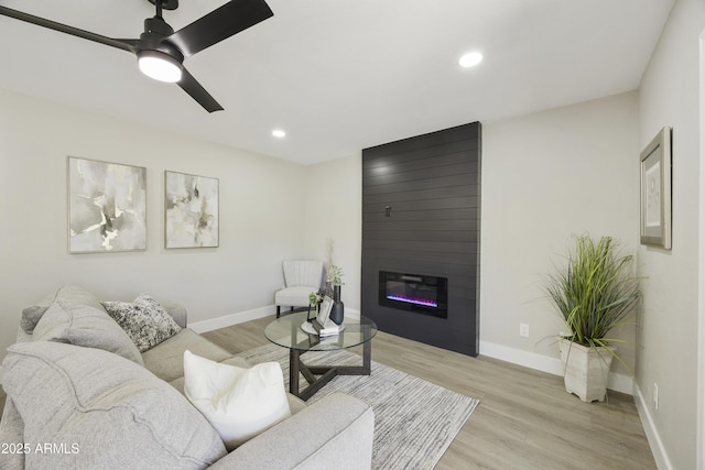 10538 E Gold Dust Cir, Scottsdale, AZ 85258 - living room featuring light wood-type flooring, a fireplace, recessed lighting, and a ceiling fan