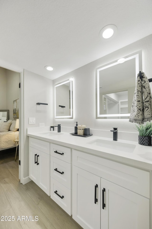 10538 E Gold Dust Cir, Scottsdale, AZ 85258 - bathroom with double vanity, wood finished floors, and ensuite bathroom
