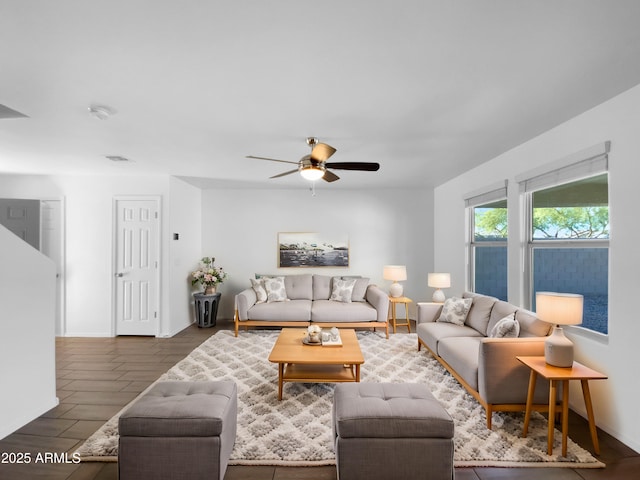 living room featuring dark hardwood / wood-style flooring and ceiling fan