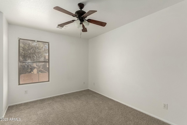 unfurnished room with carpet flooring, baseboards, a ceiling fan, and visible vents