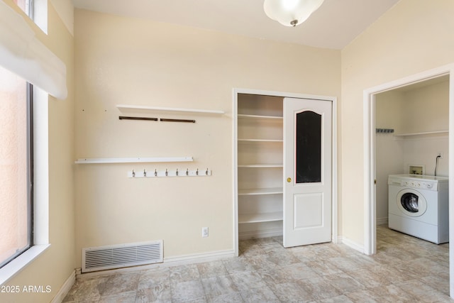 interior space with washer / dryer, visible vents, laundry area, and baseboards