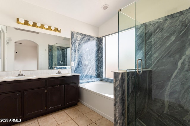 full bath featuring a garden tub, tile patterned flooring, a marble finish shower, and a sink