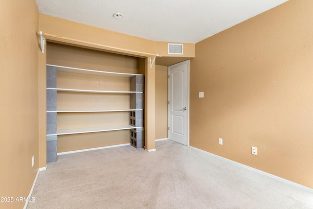 unfurnished bedroom with baseboards, visible vents, a closet, and carpet flooring