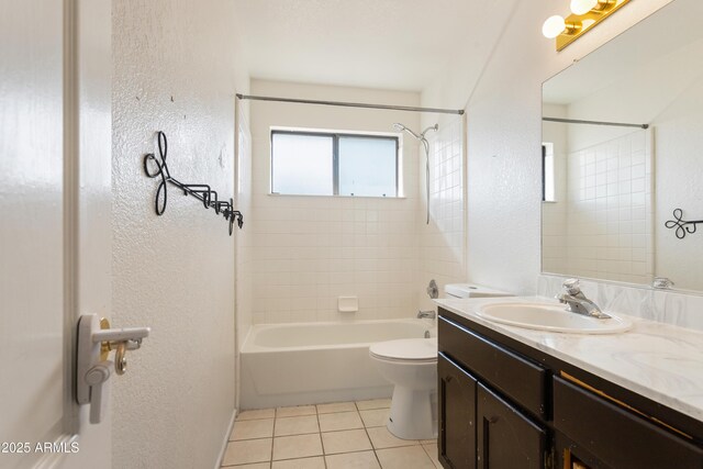 full bathroom featuring shower / bath combination, a textured wall, toilet, tile patterned floors, and vanity