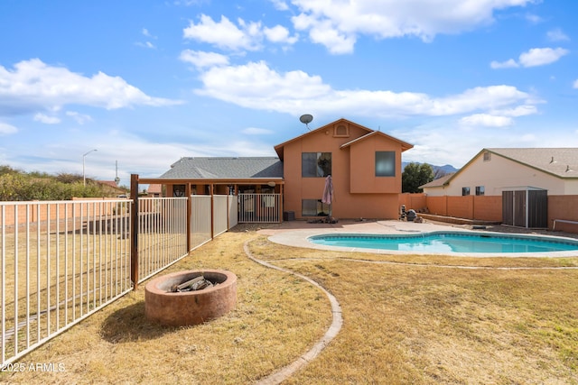 view of pool featuring a patio, an outdoor fire pit, a fenced backyard, and a fenced in pool