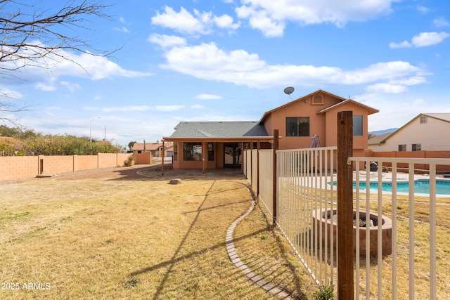 back of property with a patio area, a fenced backyard, a fenced in pool, and stucco siding