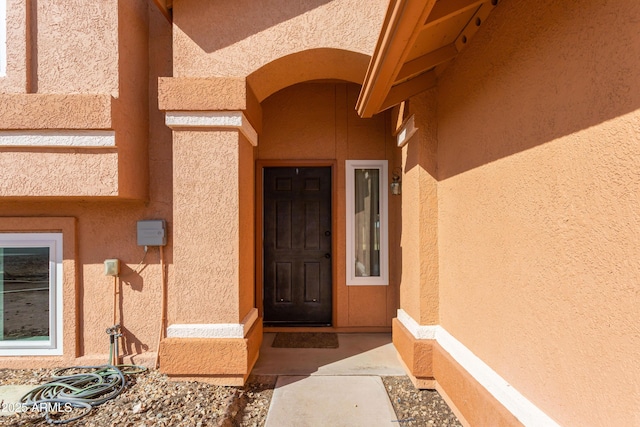 doorway to property with stucco siding