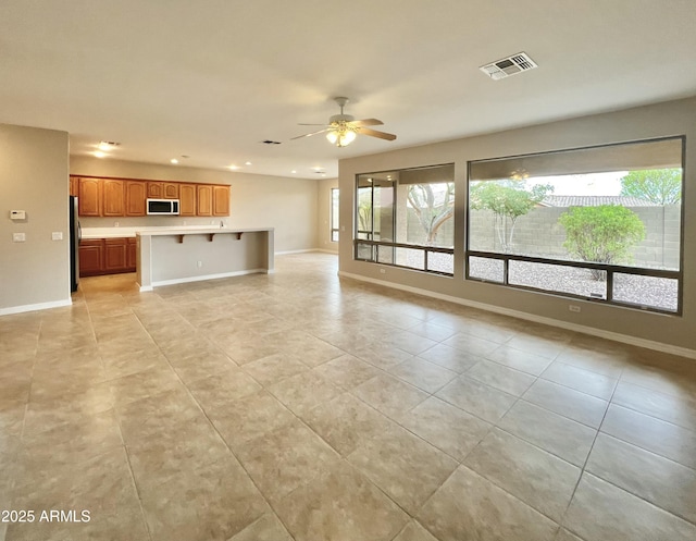 3421 W Warren Dr, Anthem, AZ 85086 - unfurnished living room featuring visible vents, baseboards, recessed lighting, a ceiling fan, and light tile patterned floors