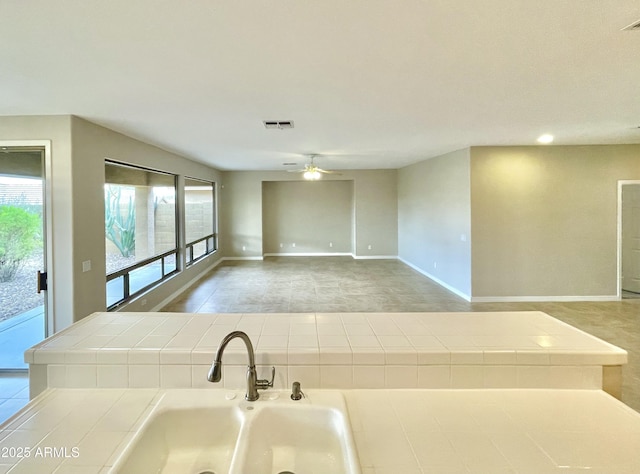 3421 W Warren Dr, Anthem, AZ 85086 - interior space featuring tile counters, open floor plan, visible vents, and ceiling fan