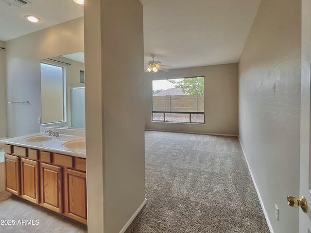 3421 W Warren Dr, Anthem, AZ 85086 - bathroom featuring visible vents, baseboards, double vanity, ceiling fan, and a sink