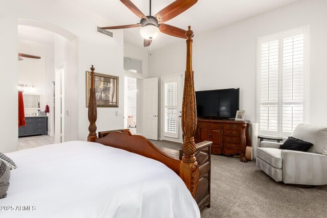 bedroom featuring ceiling fan, light carpet, connected bathroom, and visible vents