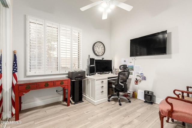 home office with baseboards, a ceiling fan, and light wood-type flooring