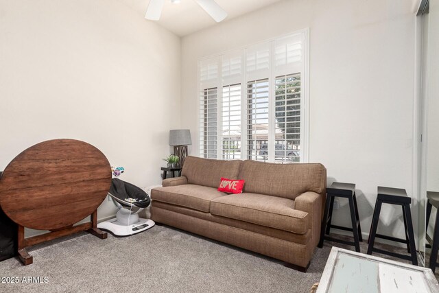 living area with carpet floors and ceiling fan