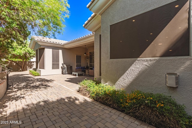 view of patio / terrace featuring ceiling fan, fence, and an outdoor hangout area