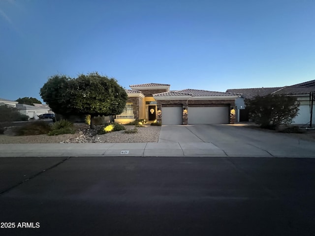 621 W Desert Ave, Gilbert, AZ 85233 - prairie-style house with driveway, a tile roof, a garage, stone siding, and stucco siding