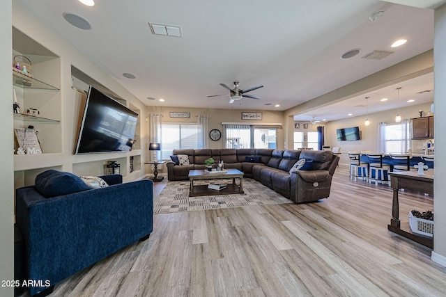 living area featuring recessed lighting, a ceiling fan, visible vents, and light wood-type flooring