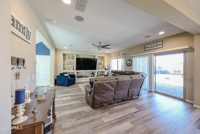living room featuring visible vents, light wood-style flooring, built in features, recessed lighting, and ceiling fan