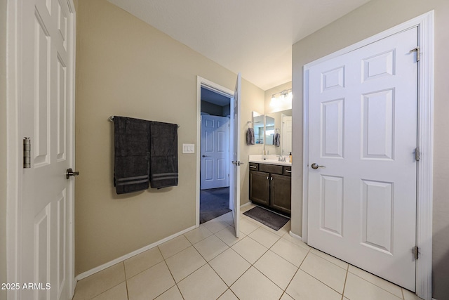bathroom with tile patterned floors, vanity, and baseboards