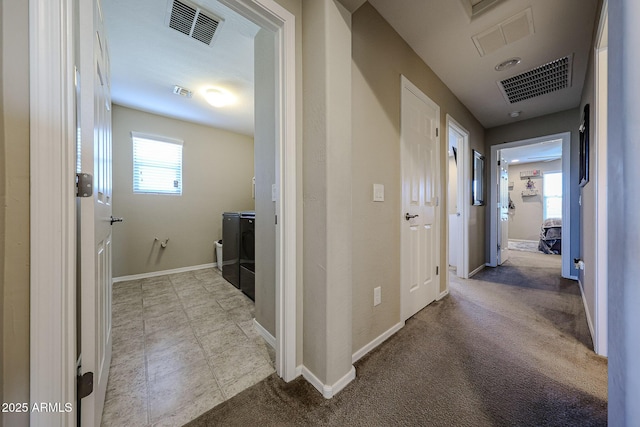 corridor with visible vents, baseboards, and carpet flooring