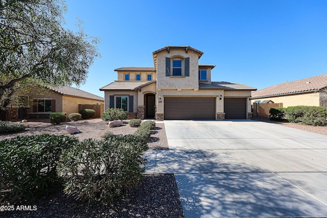 view of front facade with stucco siding, stone siding, fence, concrete driveway, and an attached garage