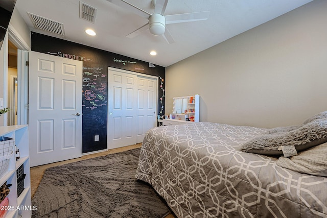 bedroom with a closet, visible vents, recessed lighting, and a ceiling fan