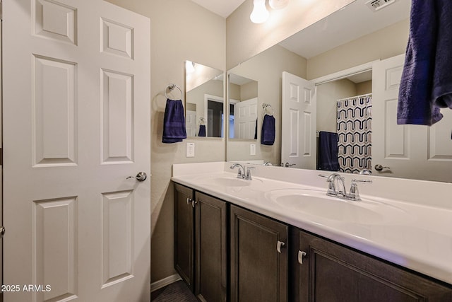full bathroom with a sink, visible vents, and double vanity