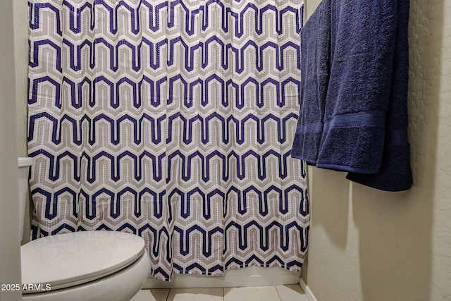 bathroom with tile patterned floors, toilet, and a shower with shower curtain