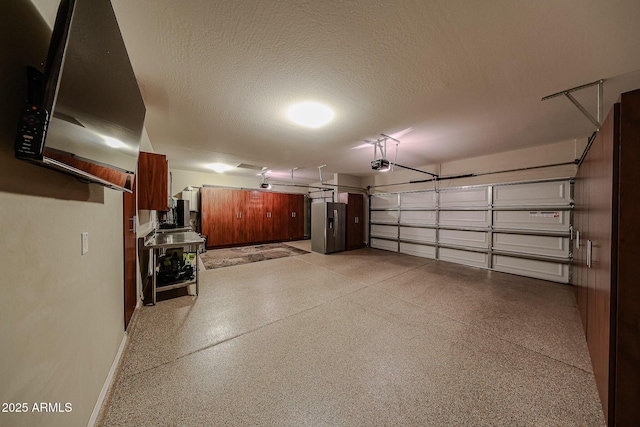 garage with a garage door opener and baseboards