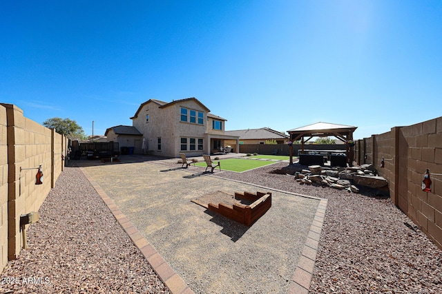 exterior space featuring a gazebo, a patio, and a fenced backyard