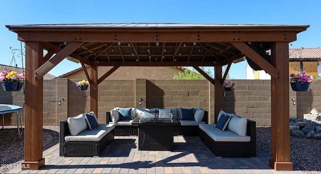 view of patio / terrace with a gazebo, an outdoor living space, and a fenced backyard