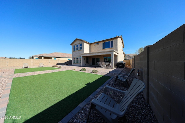back of property featuring a patio area, a lawn, a fenced backyard, and stucco siding