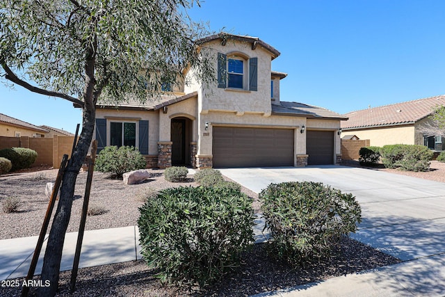 view of front of house featuring stucco siding, stone siding, concrete driveway, and fence