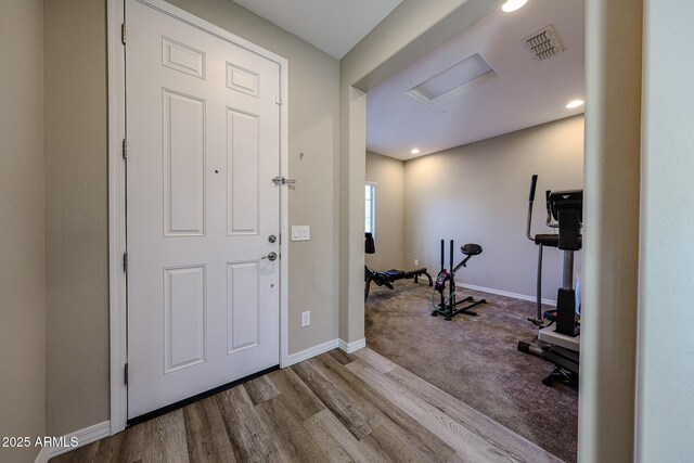 entrance foyer with visible vents, baseboards, and wood finished floors