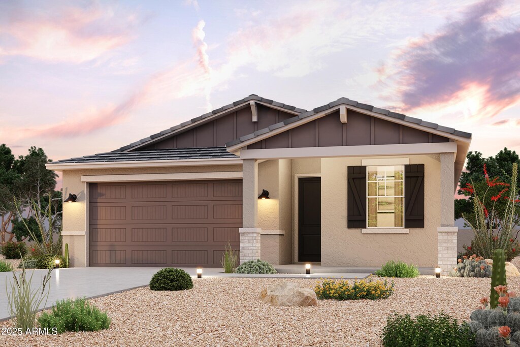 2614 E Music Mountain Ave, Apache Junction, AZ 85119 - view of front of home featuring driveway, a garage, stucco siding, covered porch, and board and batten siding