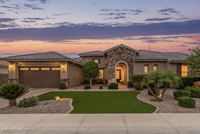 3400 S Whetstone Pl, Chandler, AZ 85286 - mediterranean / spanish-style house with stone siding, driveway, stucco siding, and a garage