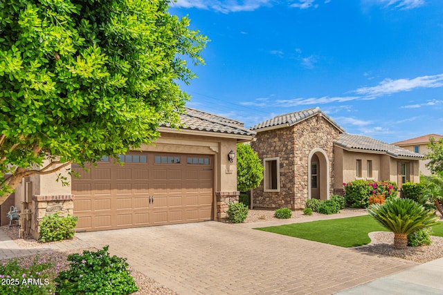 3400 S Whetstone Pl, Chandler, AZ 85286 - mediterranean / spanish home with stone siding, a tile roof, decorative driveway, and stucco siding
