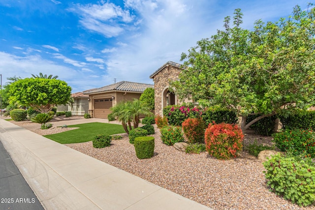 3400 S Whetstone Pl, Chandler, AZ 85286 - view of front of house featuring an attached garage, stucco siding, a tile roof, concrete driveway, and stone siding