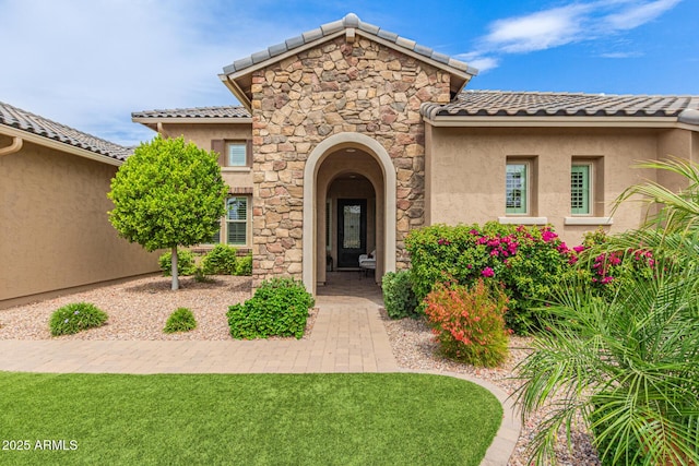 3400 S Whetstone Pl, Chandler, AZ 85286 - entrance to property featuring a tiled roof, stucco siding, and stone siding