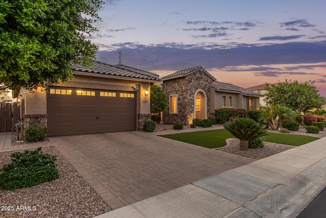 3400 S Whetstone Pl, Chandler, AZ 85286 - mediterranean / spanish-style house with stone siding, driveway, a garage, and stucco siding