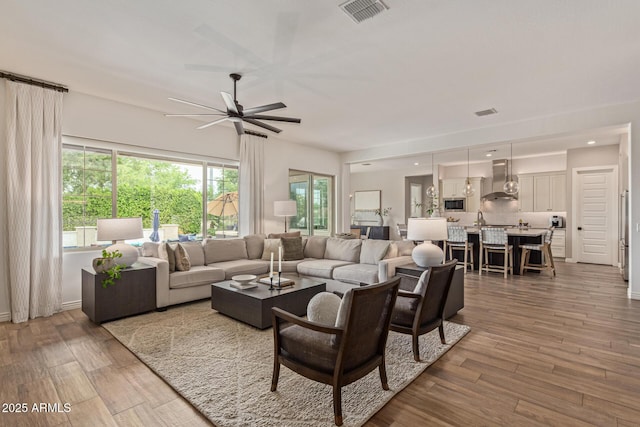 3400 S Whetstone Pl, Chandler, AZ 85286 - living room with ceiling fan, wood finished floors, and plenty of natural light