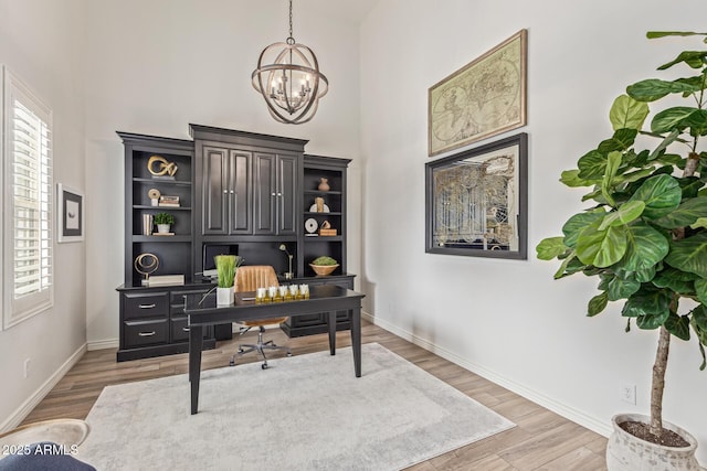 3400 S Whetstone Pl, Chandler, AZ 85286 - office area featuring a towering ceiling, a chandelier, light wood-style floors, and baseboards