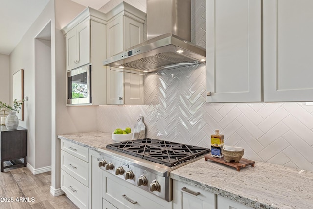 3400 S Whetstone Pl, Chandler, AZ 85286 - kitchen featuring extractor fan, appliances with stainless steel finishes, light stone counters, tasteful backsplash, and baseboards