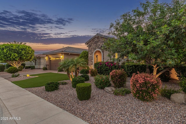 3400 S Whetstone Pl, Chandler, AZ 85286 - view of front of home with an attached garage, stone siding, a tile roof, stucco siding, and a front yard