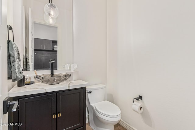 3400 S Whetstone Pl, Chandler, AZ 85286 - bathroom featuring vanity, toilet, wood finished floors, and baseboards