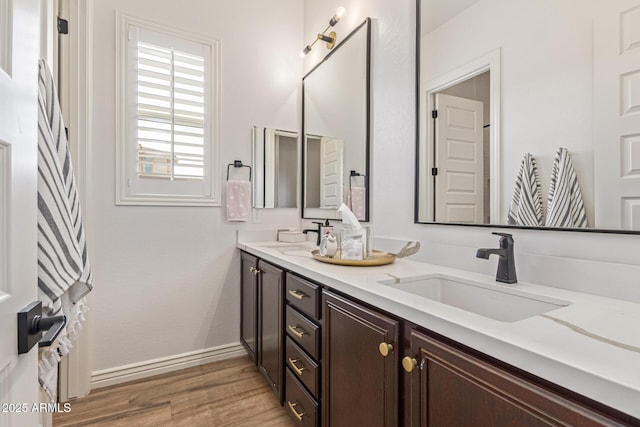 3400 S Whetstone Pl, Chandler, AZ 85286 - bathroom featuring double vanity, wood finished floors, and baseboards