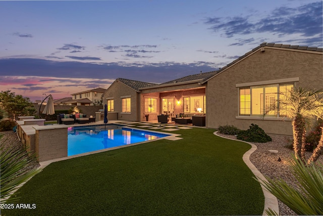 3400 S Whetstone Pl, Chandler, AZ 85286 - pool at dusk featuring outdoor lounge area, a lawn, and a patio